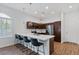 Modern kitchen featuring a spacious island with bar seating, stainless steel appliances, and stylish pendant lighting at 6447 Wide Sky St, Las Vegas, NV 89166