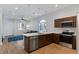 Modern kitchen features stainless steel appliances, a breakfast bar, and pendant lighting at 6447 Wide Sky St, Las Vegas, NV 89166