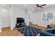 Bright living room features wood floors, large windows, and a comfortable seating area at 6447 Wide Sky St, Las Vegas, NV 89166