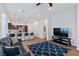 Inviting open-concept living room showcasing wood floors, modern decor, and access to the kitchen at 6447 Wide Sky St, Las Vegas, NV 89166