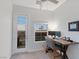Bright office featuring neutral walls, carpet, ceiling fan, balcony access and a modern desk at 6447 Wide Sky St, Las Vegas, NV 89166