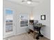 Bright office featuring neutral walls, carpet, ceiling fan, balcony access and a modern desk at 6447 Wide Sky St, Las Vegas, NV 89166
