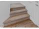 Interior staircase with carpeted steps leading to an upper level, adjacent to a stylish wood floor at 6447 Wide Sky St, Las Vegas, NV 89166