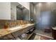 Sleek bathroom with a double vanity, stone countertop, and glass-enclosed shower at 6923 Emerald Springs Ln, Las Vegas, NV 89113