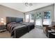 Bright bedroom with two beds, an armchair, and large windows, creating a welcoming retreat at 6923 Emerald Springs Ln, Las Vegas, NV 89113