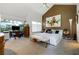 Bright bedroom features a modern bed, stylish decor, and large windows overlooking the backyard at 6923 Emerald Springs Ln, Las Vegas, NV 89113