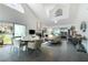 Bright living room featuring a dining area, large windows, and modern furnishings at 6923 Emerald Springs Ln, Las Vegas, NV 89113