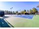 Outdoor tennis courts feature black chain-link fencing and lighting for evening play at 6923 Emerald Springs Ln, Las Vegas, NV 89113