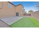 Backyard featuring a mix of modern patio, artificial turf, and stone features at 7200 Mineral Park Ave, Las Vegas, NV 89179