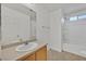 Bathroom featuring a vanity with storage and a shower-tub combo at 7200 Mineral Park Ave, Las Vegas, NV 89179