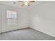 Cozy bedroom with neutral carpet, a ceiling fan, and a bright window at 7200 Mineral Park Ave, Las Vegas, NV 89179