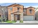 Charming two-story home featuring stone accents, a well-manicured lawn, and an attached two-car garage at 7200 Mineral Park Ave, Las Vegas, NV 89179