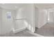 Upstairs hallway with gray carpet, white walls, and a window at the landing at 7200 Mineral Park Ave, Las Vegas, NV 89179