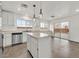 Bright kitchen features stainless steel appliances, central island, and sliding door to outdoor patio at 7200 Mineral Park Ave, Las Vegas, NV 89179