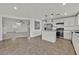 Open concept kitchen with stainless steel appliances and a view of the living room and entry at 7200 Mineral Park Ave, Las Vegas, NV 89179