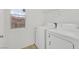 Functional laundry room with a window and modern washer and dryer at 7200 Mineral Park Ave, Las Vegas, NV 89179