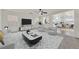 A stylish living room with modern furnishings, a ceiling fan, and a view into the adjacent kitchen at 7200 Mineral Park Ave, Las Vegas, NV 89179
