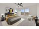The main bedroom offers neutral decor, windows with natural light, and ceiling fan at 7200 Mineral Park Ave, Las Vegas, NV 89179
