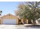 Charming single-story home featuring a two-car garage and well-maintained front yard with mature tree at 7405 Painted Ridge St, Las Vegas, NV 89131
