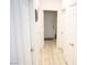 Hallway with neutral walls, white trim and doors, and light wood flooring at 7405 Painted Ridge St, Las Vegas, NV 89131