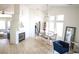 Open-concept living room with a fireplace, dining area, and lots of natural light at 7405 Painted Ridge St, Las Vegas, NV 89131