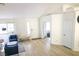 Bright living room with hardwood floors, large windows, and stylish blue accent chairs at 7405 Painted Ridge St, Las Vegas, NV 89131