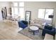 Open-concept living room with a dining area, lots of natural light, and modern decor at 7405 Painted Ridge St, Las Vegas, NV 89131