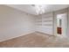 Bright bedroom featuring built in shelves with an open doorway to an attached bathroom with a granite counter at 746 Oakmont Ave # 708, Las Vegas, NV 89109