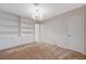 Bright bedroom featuring a modern chandelier and built-in shelving unit with cabinets for ample storage at 746 Oakmont Ave # 708, Las Vegas, NV 89109