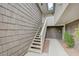 Exterior stairway entrance featuring neutral siding, an overhead skylight, and lush landscaping at 746 Oakmont Ave # 708, Las Vegas, NV 89109
