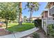 Well-maintained front yard with mature trees, green grass, and a sidewalk leading to the building at 746 Oakmont Ave # 708, Las Vegas, NV 89109