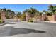 Grand gated entrance with decorative stonework, wrought iron gates, and lush landscaping at 746 Oakmont Ave # 708, Las Vegas, NV 89109