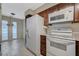 Kitchen featuring tile floors, white appliances, and access to the bright breakfast nook at 746 Oakmont Ave # 708, Las Vegas, NV 89109