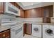 Bright kitchen with white appliances, granite countertops, tile floor, and washer/dryer at 746 Oakmont Ave # 708, Las Vegas, NV 89109