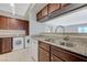 Kitchen with granite countertops, undermounted sink, tile flooring, and washer/dryer hookups at 746 Oakmont Ave # 708, Las Vegas, NV 89109