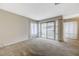 Bright, carpeted living room with access to the balcony and large windows with natural light at 746 Oakmont Ave # 708, Las Vegas, NV 89109