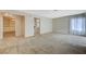 Spacious living room with neutral walls, carpet flooring, and access to additional rooms at 746 Oakmont Ave # 708, Las Vegas, NV 89109
