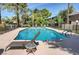 Inviting community pool with lounge chairs, mature landscaping, and a tranquil atmosphere at 746 Oakmont Ave # 708, Las Vegas, NV 89109