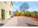 This backyard has a small brick patio with chairs and easy to maintain desert landscaping at 7529 Earnshaw Avenue Ct, Las Vegas, NV 89179