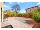 Spacious backyard with stone pavers, gravel, and mature landscaping at 7529 Earnshaw Avenue Ct, Las Vegas, NV 89179