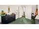 Clean bedroom with green carpet and black cabinet decorated with a tree at 7529 Earnshaw Avenue Ct, Las Vegas, NV 89179