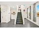 Inviting entryway featuring tiled floors, a staircase, and natural light from large windows at 7529 Earnshaw Avenue Ct, Las Vegas, NV 89179