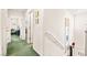 Bright hallway featuring white walls, artwork, and access to multiple rooms on the second floor at 7529 Earnshaw Avenue Ct, Las Vegas, NV 89179