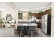 Modern kitchen featuring granite countertops, stainless steel appliances, and a breakfast bar at 7529 Earnshaw Avenue Ct, Las Vegas, NV 89179