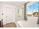 Bright main bathroom features a glass shower enclosure, a bathtub, and bright natural light at 7529 Earnshaw Avenue Ct, Las Vegas, NV 89179