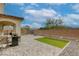 Spacious backyard with a brick-paved patio, small turf area, and brick perimeter wall, perfect for outdoor living at 7579 Harwich Bay Ave, Las Vegas, NV 89179