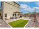 Large backyard features brick-paved patio, turf area, and a built-in BBQ, ideal for entertaining and recreation at 7579 Harwich Bay Ave, Las Vegas, NV 89179