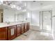 Bright bathroom featuring double sinks, soaking tub, and glass shower at 7579 Harwich Bay Ave, Las Vegas, NV 89179