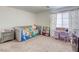 Bedroom with large window providing natural light and cozy decor at 7579 Harwich Bay Ave, Las Vegas, NV 89179