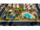 Aerial view of the community pool and playground with ample shade and lounge areas at 7579 Harwich Bay Ave, Las Vegas, NV 89179